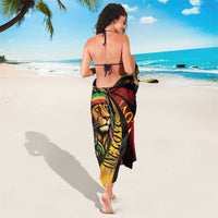Black beach sarong with lion face and red yellow circular graphic, wrap style