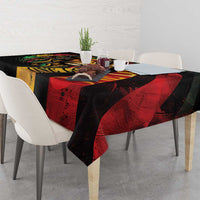 Tablecloth with lion face centerpiece and red, yellow, and black abstract bands