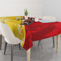Sicily region tablecloth in gold and red, draped over dining table edge