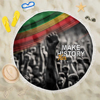 Round beach blanket with black-and-white “Make History Her” graphic and fringe edge