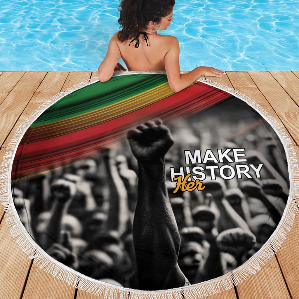 Round beach blanket with “Make History Her” graphic and green-red striped fabric border