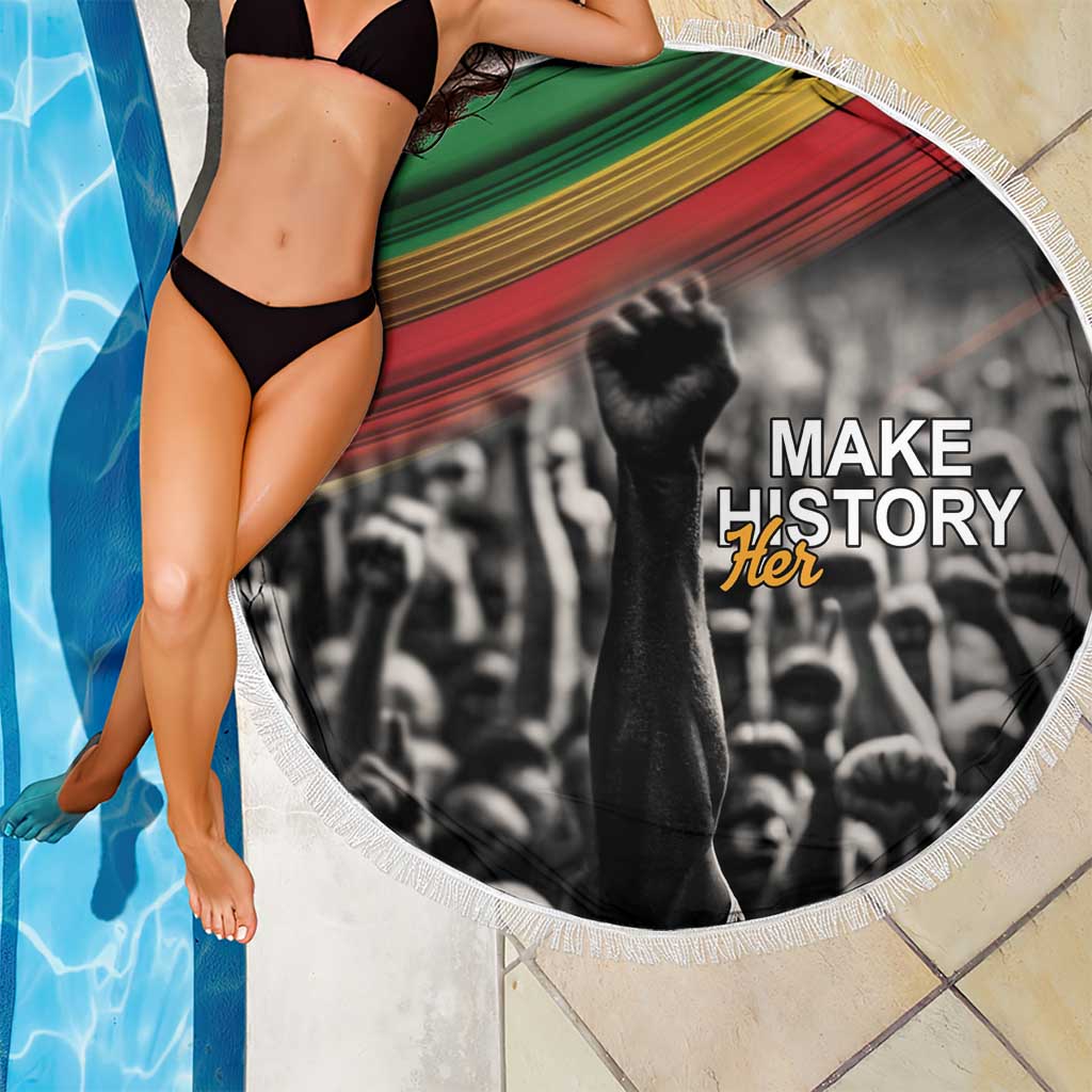 Round beach blanket with “Make History Her” black-and-white image, fringe trim, green-red stripes