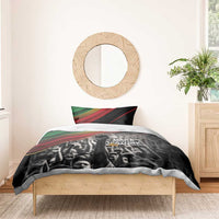 Black duvet with crowd portrait print, green-red stripe top, one pillow visible
