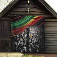 Black quilt displayed on porch, Pan-African diagonal stripe and 'MAKE HISTORY Her' graphic text