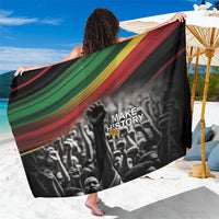 Black sarong with red, green, and gold stripes and “Make History Her” graphic