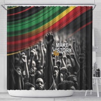 Black shower curtain featuring diagonal pan-African stripes and crowd scene with raised fist