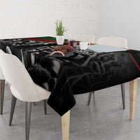 Black tablecloth with bold portrait-style figures and “Make History Her” text; multicolor stripe edge