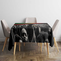 Black tablecloth on table with “Make History Her” text over grayscale figure collage print