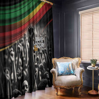 Black window curtain with “Make History Her” and African flag stripe pattern, close view