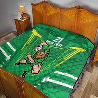 Green quilt blanket on bed with Irish warrior mascot, “21 YOUR TEXT,” and yellow rays.