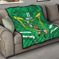 Green quilt blanket on gray sofa with Irish warrior mascot, “21 YOUR TEXT,” yellow ray accents.