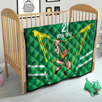 Green quilt blanket on toddler bed with Irish warrior mascot, “21 YOUR TEXT,” yellow rays.