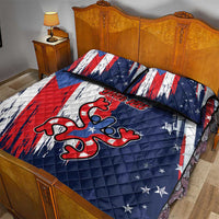 Blue quilt bed set with red and white stripes and star pattern; oversized frog logo on quilt.