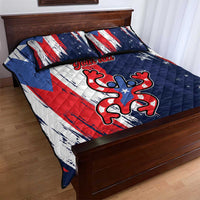 Blue quilt bed set with quilted pattern, red and white stripes, stars and central frog emblem.