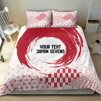 Red and white bedding set featuring duvet cover with circle emblem and grid-and-wave design