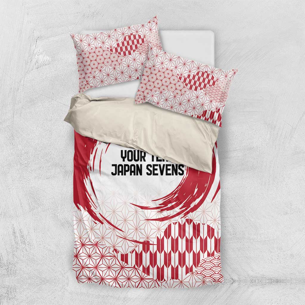 Red and white comforter and pillowcases with circle emblem, geometric pattern, and waves