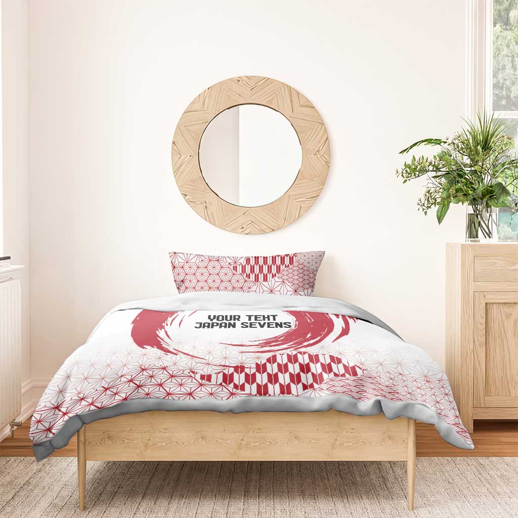 Red and white duvet and pillow set with circle emblem, geometric shapes, and wave motif