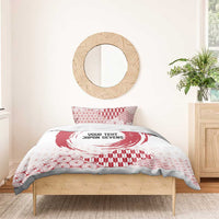 Red and white duvet and pillow set with circle emblem, geometric shapes, and wave motif