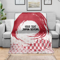 Red and white Japan Sevens blanket with circular brush motif and geometric pattern