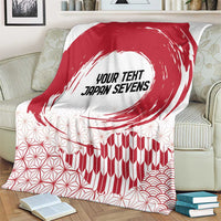 Red and white blanket showing “YOUR TEXT JAPAN SEVENS” with wave and geometric design