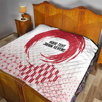 White quilt on a bed with red rising sun graphic, 'YOUR TENT JAPAN SEVENS' text, and waves.