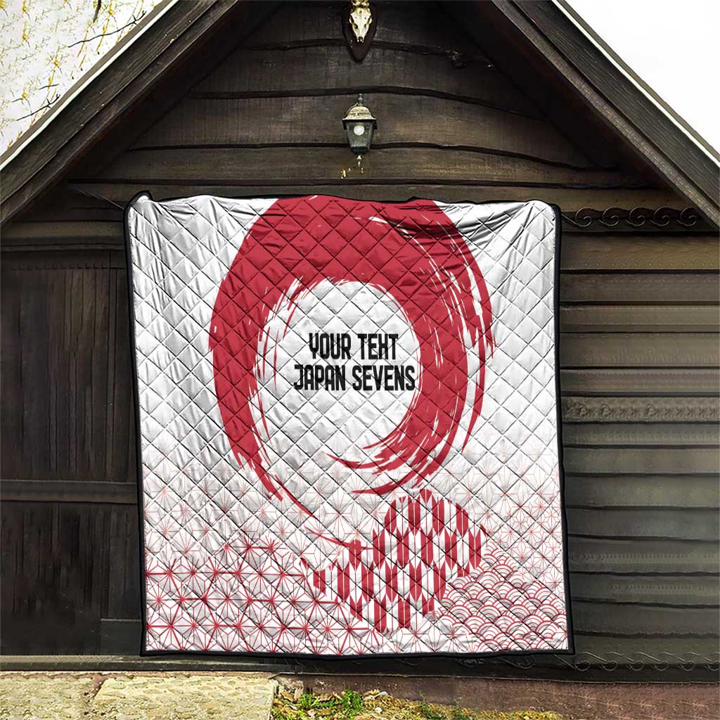 White quilt featuring red rising sun center and diagonal red geometric lines with wave details.