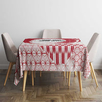 Red and white tablecloth with geometric lattice and wave patterns over dining table