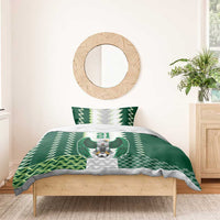 Green bedding set on bed with eagle crest, zigzag background, and “YOUR TEXT 21” print