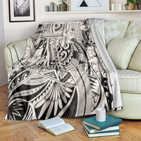Tribal polynesian print throw blanket draped on couch, black-and-white geometric flowers
