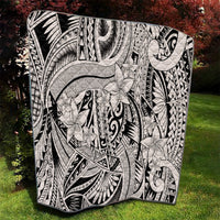Tribal quilt blanket in black and white with swirling lines and layered floral shapes