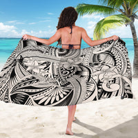Black-and-white tribal floral sarong with bold tiki-style patterns, held wide