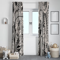 Two-panel tribal window curtains in black and light gray hanging on either side of a door