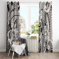 Tribal curtain panels in black and light gray framing a window with floral and fan patterns