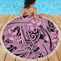 Pink round fringed beach blanket with tribal geometric designs and floral accents