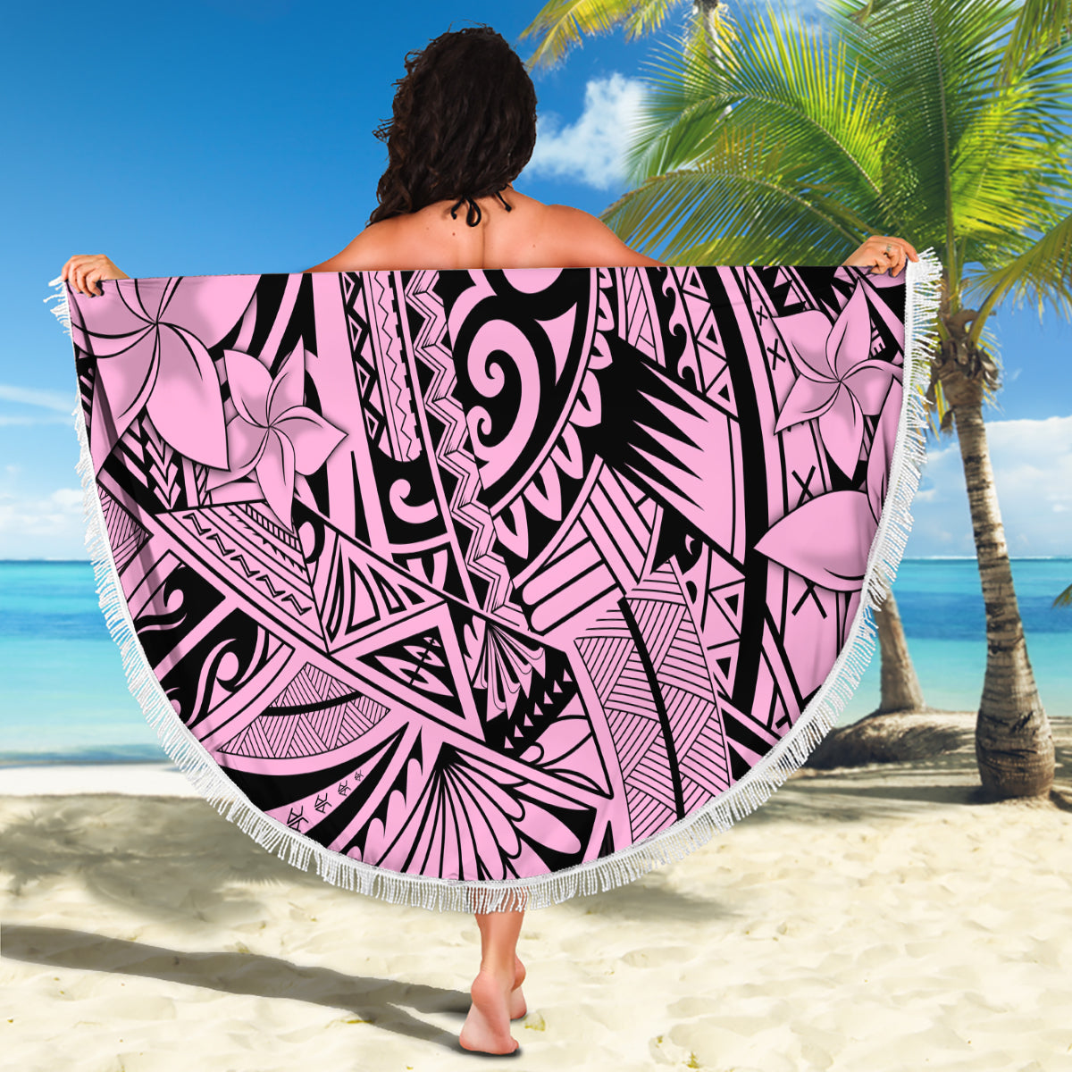 Pink round beach blanket with black tribal pattern, large floral center, fringed border