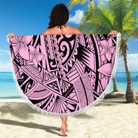 Pink round beach blanket with black tribal pattern, large floral center, fringed border