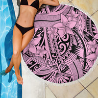 Pink round beach blanket with bold black tribal swirls and flower print, fringed trim