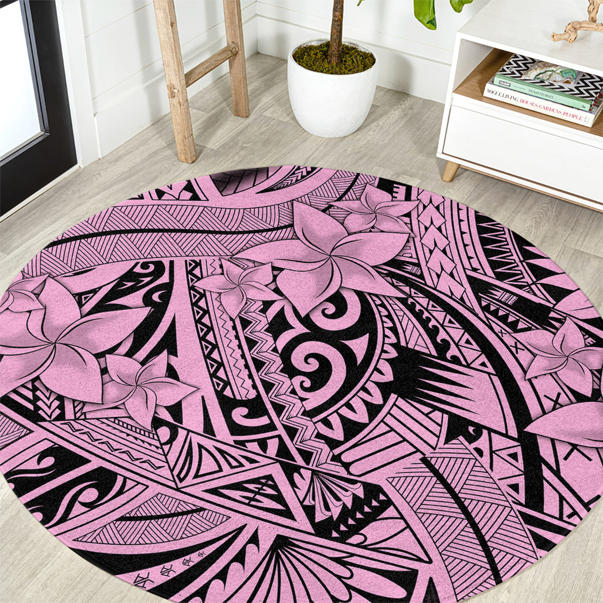 Round pink tribal area rug with floral and swirl pattern, black accents