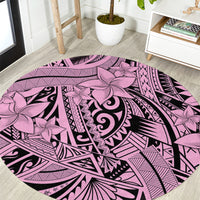 Round pink tribal area rug with floral and swirl pattern, black accents