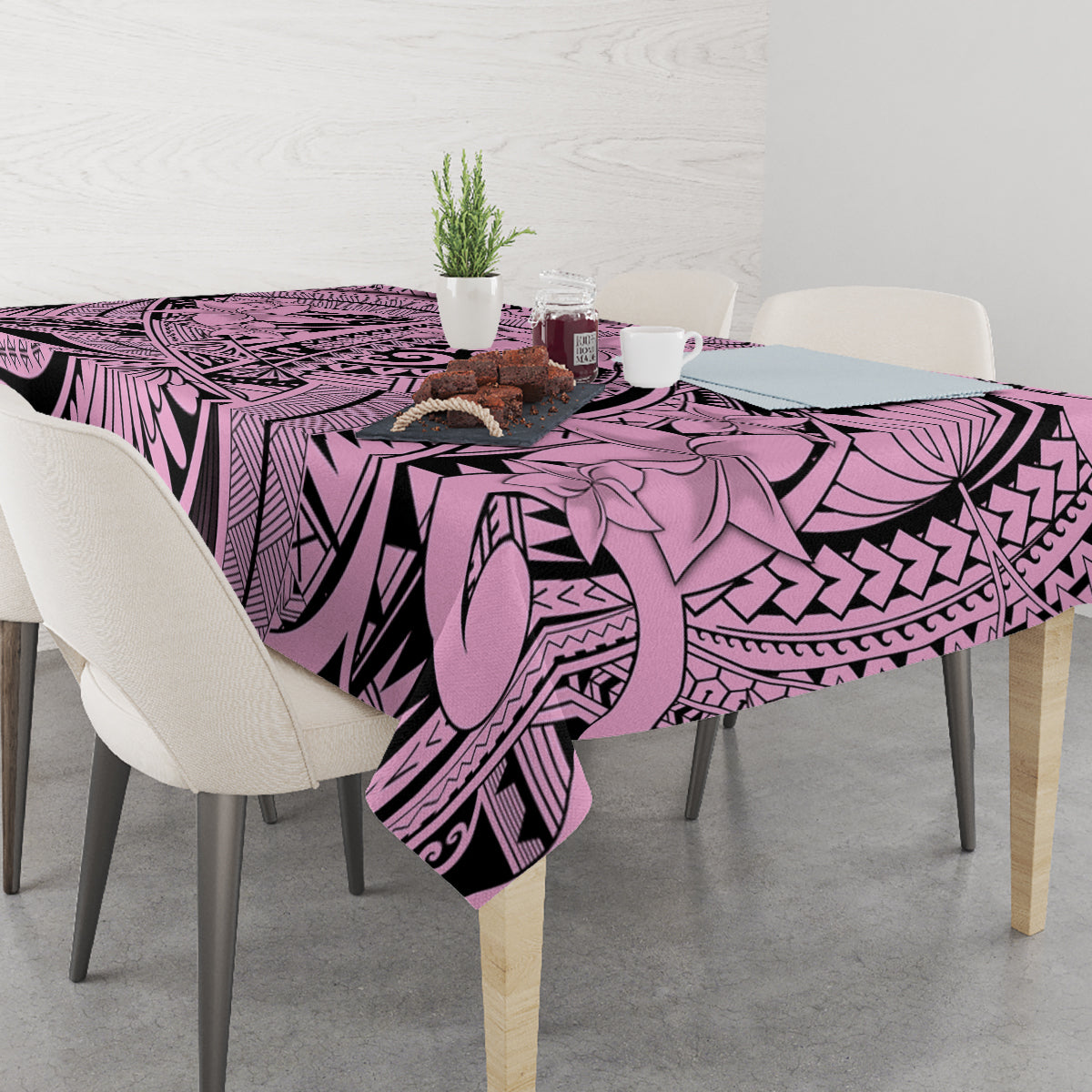 Pink and purple Polynesian-style tablecloth with bold tribal pattern and floral elements