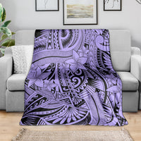 Violet tribal blanket with floral and geometric motifs, spread across a couch