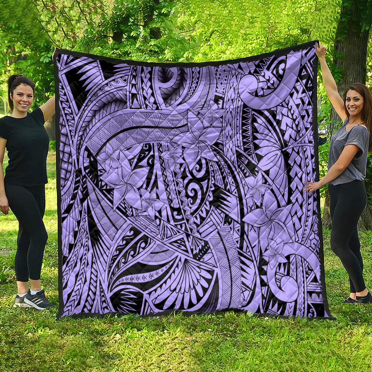 Violet tribal quilt draped outdoors, featuring black lines and tropical flower motifs