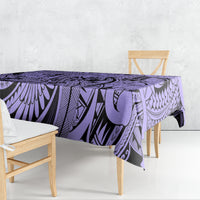 Violet tablecloth draped over rectangular table with black tribal linework
