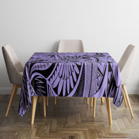 Violet tablecloth with geometric tribal design and black accents on dining table