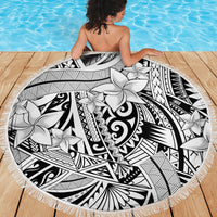 White round beach blanket with black tribal motifs and large flower prints, fringed edge