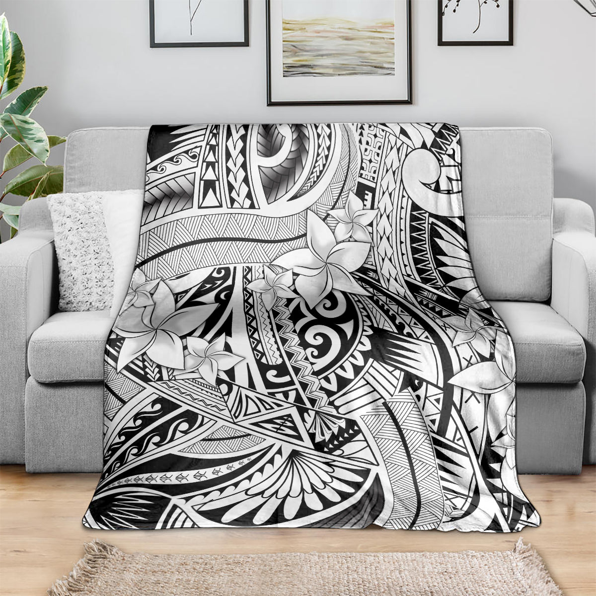 Black and white tribal floral blanket draped over a sofa