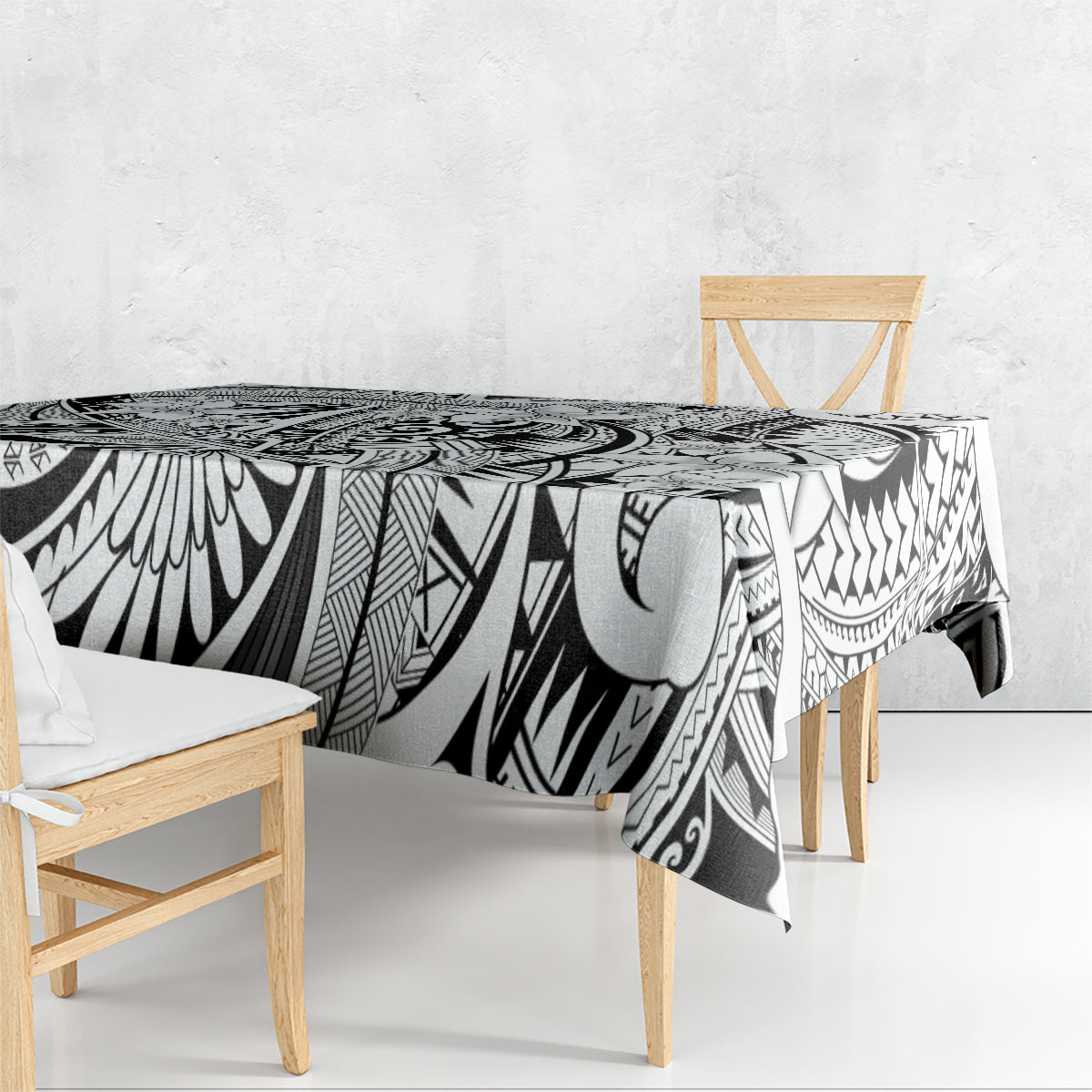 Tribal tablecloth draped over dining table, black-and-white geometric tiki design