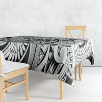 Tribal tablecloth draped over dining table, black-and-white geometric tiki design