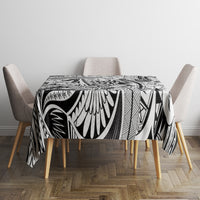 Tribal tablecloth with bold black-and-white tiki motifs, neatly covering dining table