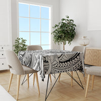 Black-and-white tribal tablecloth with tiki and floral patterns on dining room table